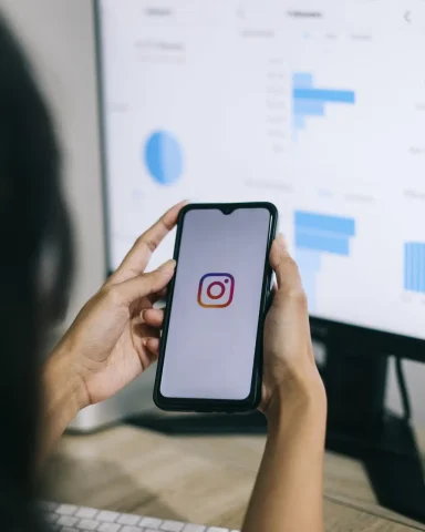 hands-holding-mobile-phone-with-instagram-logo-icon-instagram-growth-trend-graph-report-analysis-co